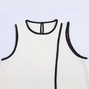 Elegant sleeveless cream knit top with black contrast trim and textured finish
