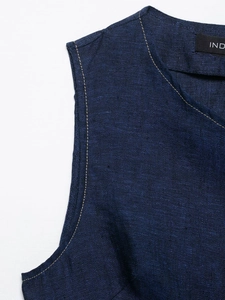 Detail view of navy linen vest featuring contrast stitching and refined fabric texture