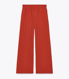 Detail of brick red cotton linen wide leg trousers with elastic waist for spring outfits