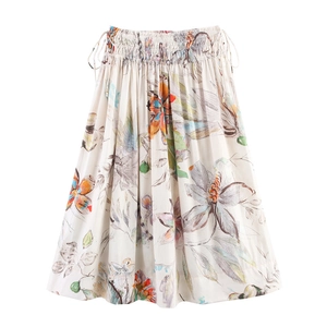 Detail of white midi A-line skirt featuring vibrant floral prints and drawstring elastic waist