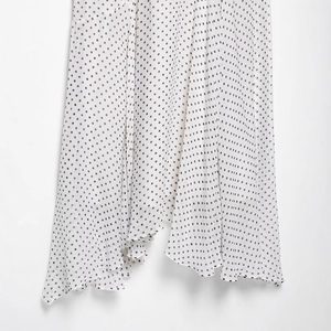 Polka dot halter neck maxi dress with ruffled hem and lightweight flowing fabric