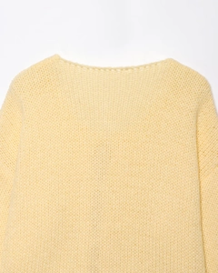 Close-up of soft yellow knit cardigan showing fine mohair texture and shoulder stitching