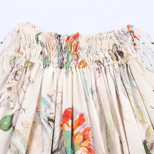 Detail of elastic smocked waistband and tropical floral print on lightweight midi skirt