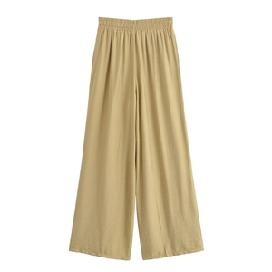 Detailed view of elastic waist on khaki wide-leg trousers with breathable linen texture