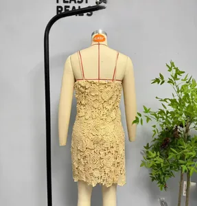 Detaillierte Rückansicht eines beigen floralen Spitzen-Minikleids mit schmalen Trägern