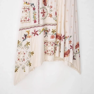Bohemian off-white dress with asymmetric embroidery and delicate hollow-out details