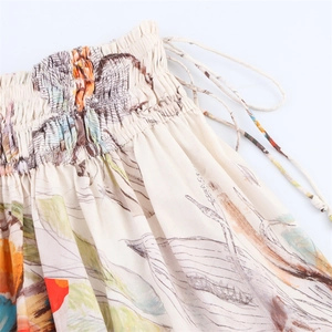 Detail of floral midi skirt showing elastic smocking waist and side drawstrings