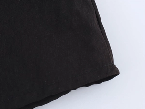 Detail view of high-density black fabric featuring precise stitching and clean seams