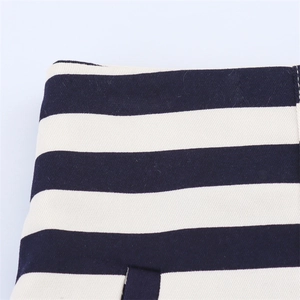 Close-up of high-waist striped fabric with navy and cream heavy canvas texture