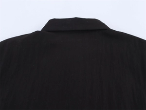 Close-up of the back neckline detail on a sleek black double-layered short sleeve shirt