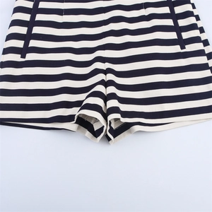Detail of high waist striped shorts featuring side pockets and black white cotton fabric