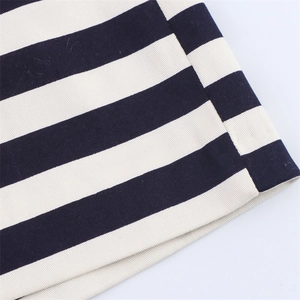 Close-up of navy and white striped twill fabric with high-quality stitching detail