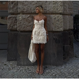 Detaillierte Nahaufnahme des eleganten beigen Spitzenkleids mit floralen Verzierungen