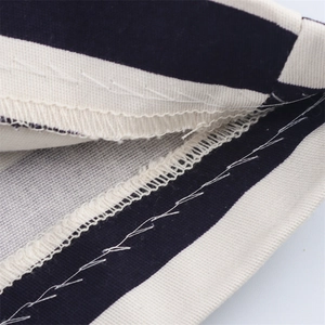 Detail macro view showing professional overlock stitch and sewing on striped fabric