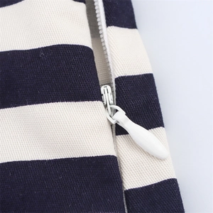 Detail shot of white invisible zipper and striped fabric texture for these casual shorts