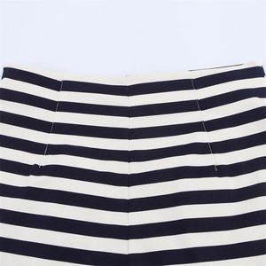 Detailed close-up of high-waisted black and white striped shorts with tailored waist darts