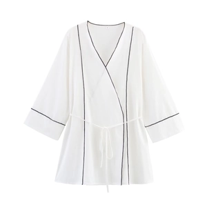Women's white V-neck wrap top with black contrast piping and waist tie for summer 2025
