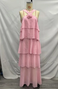 Detail of pink chiffon dress featuring 3D floral accent and tiered layered skirt