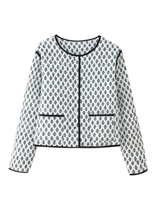 Detail of the black paisley print on the white cotton jacket with button closure