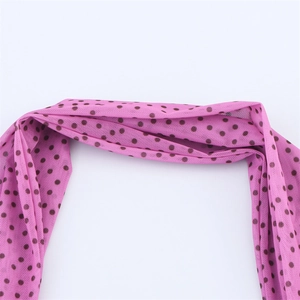 Dettaglio di tessuto a rete rosa con pois neri e texture plissettata per abiti primaverili