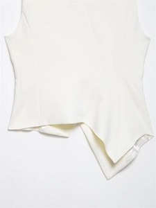 Detail of white sleeveless top with asymmetrical hem and refined draped pleats