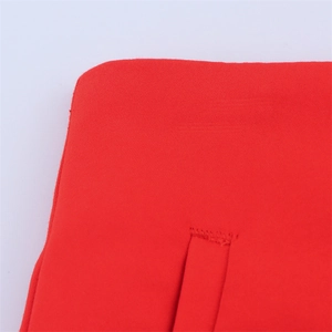 Macro detail of high-waist red casual shorts showing fabric texture and pocket stitching