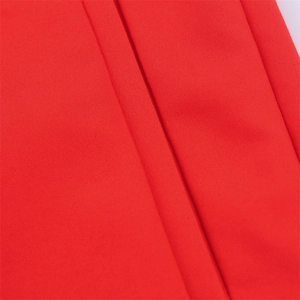 Close-up of bright red high-waisted shorts showing dense woven cotton fabric texture