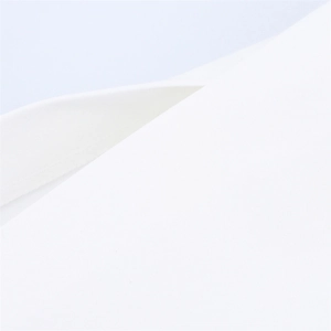 Detailed close-up of white textile fabric with fine stitching and smooth premium texture