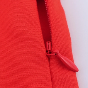 Detailed close-up showing the red high-waisted shorts with matching invisible zipper detail