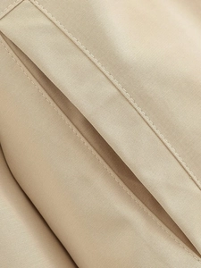 Close-up of khaki twill cotton fabric showing high-quality double-needle stitching detail