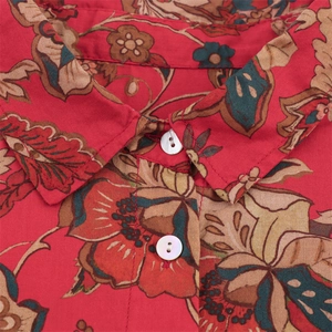 Detail of red floral print blouse showing fabric texture and pearl buttons