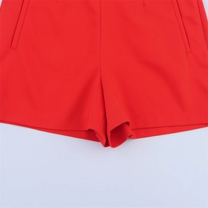 Close-up of high-waist red casual shorts showing side pockets and neat stitching details