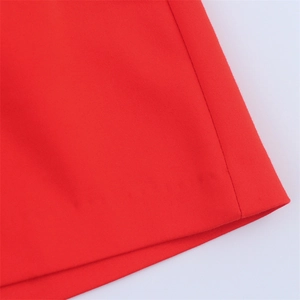 Macro shot of red high-waist casual shorts showing twill fabric texture and stitching details