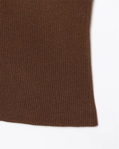 Detailed close-up of dark brown knit fabric showing refined vertical weave patterns