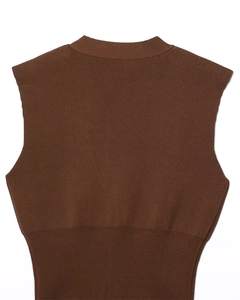 Detail of the knit texture and ribbed hem on the back of a brown sleeveless vest