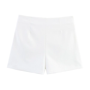 Macro detail of high-waist white shorts showing the structured fabric and vertical darts