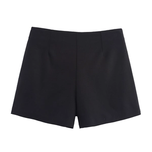 Detail view of high waisted black tailored shorts with seamless waistband and premium fabric