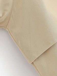 Close-up of beige twill fabric texture with neat edge stitching and durable structure