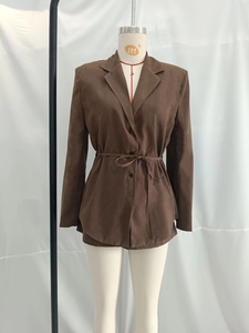 Detail of brown faux suede jacket with notched lapel and adjustable waist belt