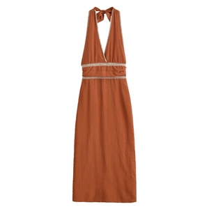 Detail of crochet lace trim and deep V-neckline on caramel halter neck summer dress