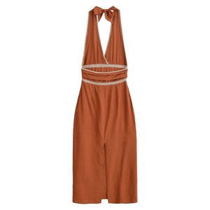 Detail of halter neck dress featuring bow tie and ethnic geometric embroidery on high waist