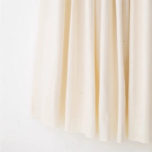 Elegant cream patchwork long dress featuring soft fabric texture and vertical drape design