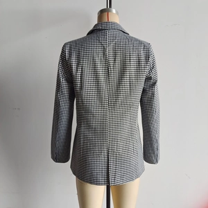 Back view of a tailored black and white houndstooth blazer on a mannequin display