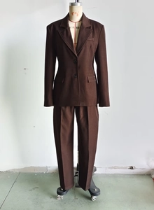 Detail view of dark brown women's two-piece suit set with blazer and trousers