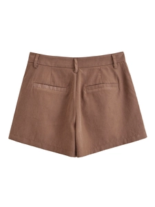 Detail view of coffee brown high-waisted shorts with belt loops and decorative pockets