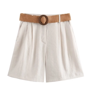 Detail of high-waist cotton linen shorts with a woven belt and round wooden buckle