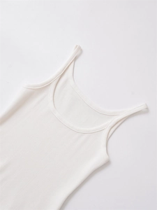 Detail shot of white ribbed knit fabric showing the soft cotton texture and strap design