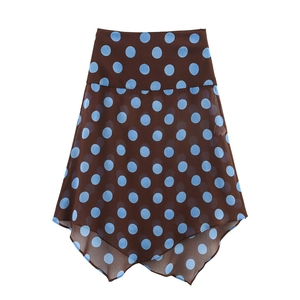 Detailed view of dark brown chiffon skirt with blue polka dots and irregular hemline