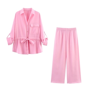 Detailed close-up of pink satin two-piece shirt set showing drawstring and pocket detail