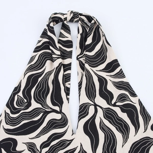 Halter neck linen blend dress featuring black and white abstract leaf print pattern